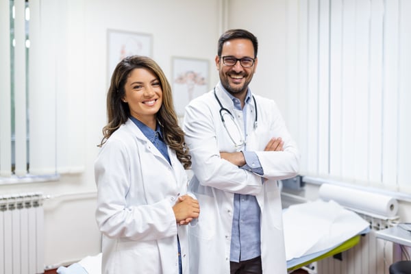 portrait-smiling-young-doctors-standing-together-portrait-medical-staff-inside-modern-hospital-smiling-camera portrait-smiling-young-doctors-standing-together-portrait-medical-staff-inside-modern-hospital-smiling-camera